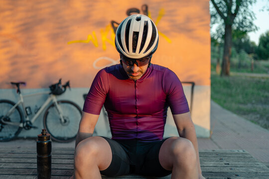 Cyclist resting after training embracing active lifestyle