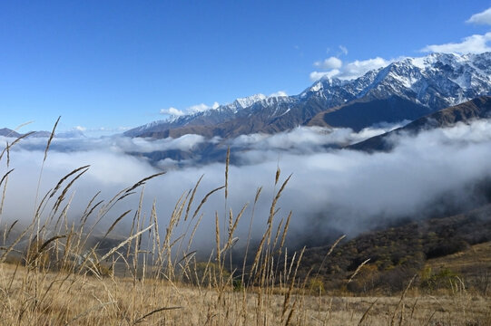 Stunning landscape with swirling clouds and snow-capped peaks