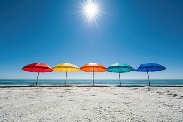 Fototapeta premium Row of vibrant beach umbrellas against a bright, sunny sky and ocean