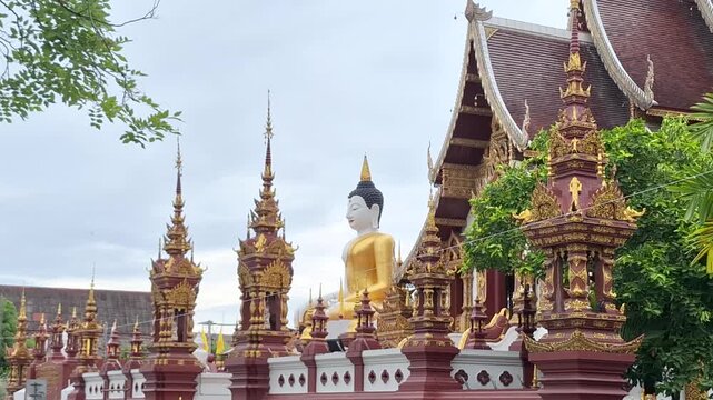 A serene and peaceful seated Buddha statue housed within a historic, traditional wooden temple sanctuary in Chiang Mai, Thailand.
