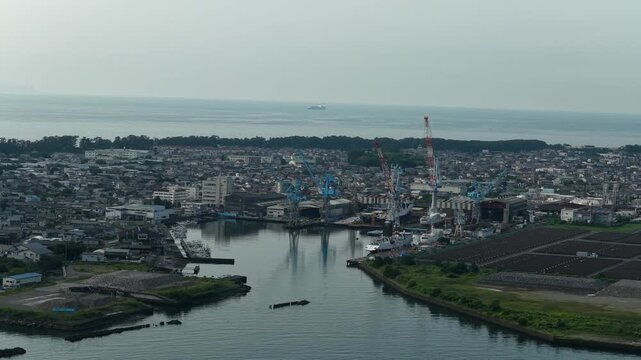 Aerial drone footage of Shimizu Port shipyard and industrial waterway in Shizuoka, Japan