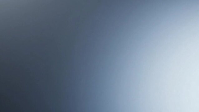 A smooth, soft gradient transitioning from dark blue-grey to light blue-white, creating an abstract and calming background.