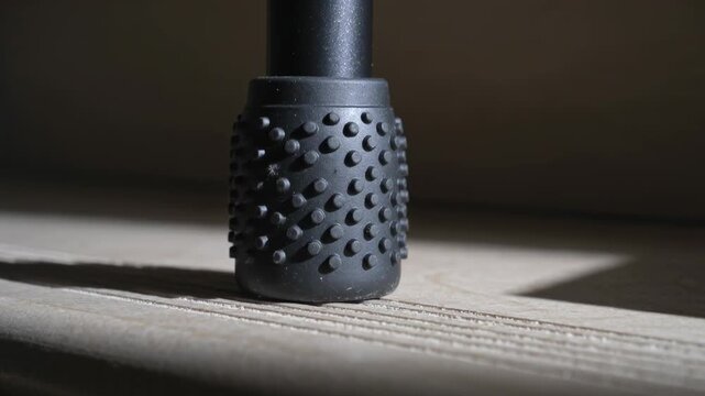 Light shift causing textured rubber end cap on short rod lifting then settling on grooved floor