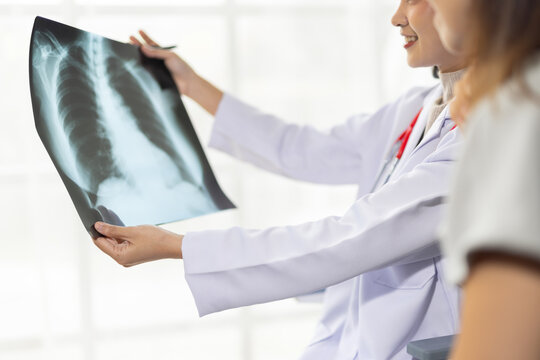 Female doctor explaining x-ray scan to patient.