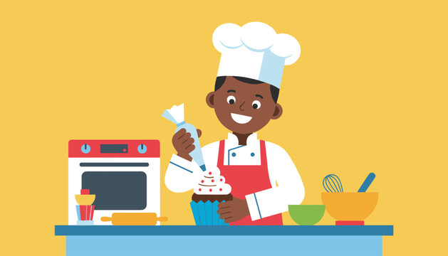 Happy young boy wearing a white chef hat and red apron frosting a sweet chocolate cupcake with a piping bag in a kitchen.