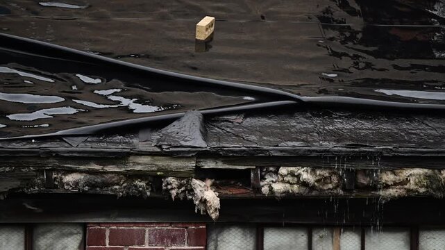 Rundown roof roofer raining flowing water, roofing industry, building renovation construction theme, bad weather.