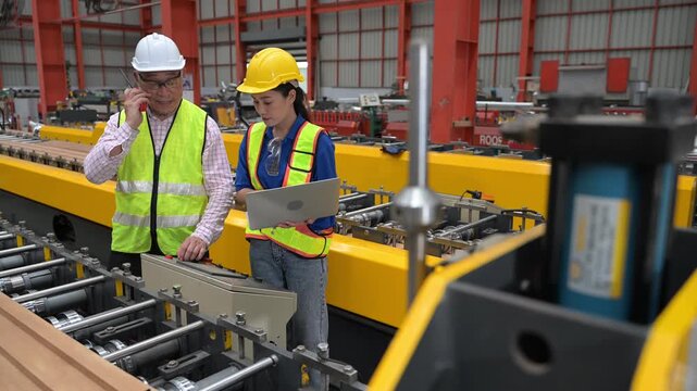 Senior engineer discussing production workflow with trainee