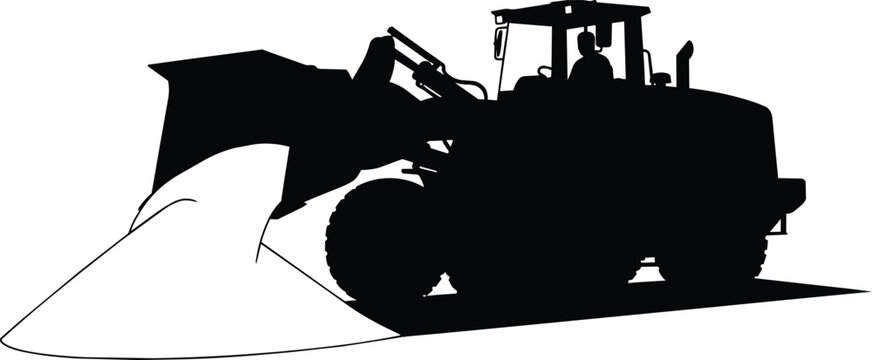 Heavy front end loader silhouette moving soil pile