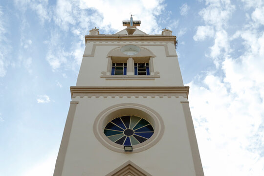 Bell tower of Saint Francis of Assis church against blue sky in Vargem Bonita