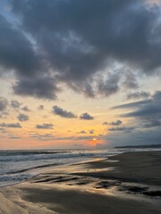 Fototapeta premium Beautiful sunset on ocean beach with dark storm clouds