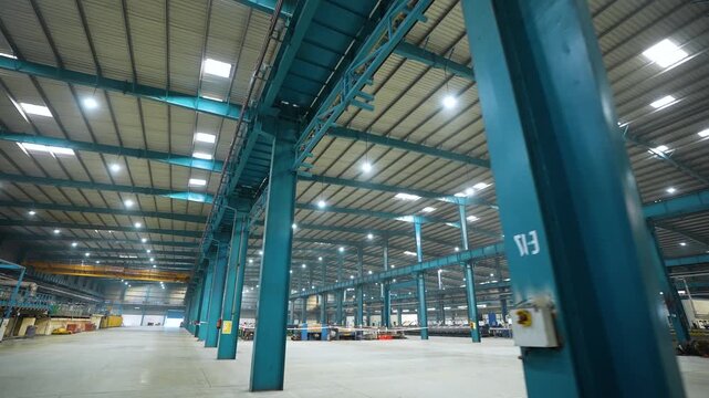 large factory inside, lifter moving inside the manufacturing plant. technical production factory. well lit production facility