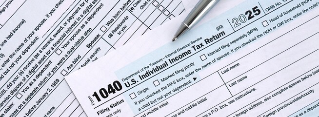 Fototapeta premium 1040 US Individual Income tax return blank form and pen on accountants table