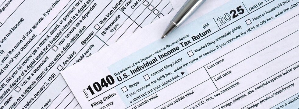 1040 US Individual Income tax return blank form and pen on accountants table