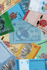 Malaysian ringgit money banknotes pile on table. Malaysia bills of MYR currency close up © Larysa