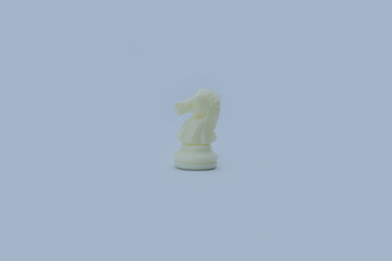 White Plastic Chess Knight on Gray Background with Copy Space © Юрий Несмашный
