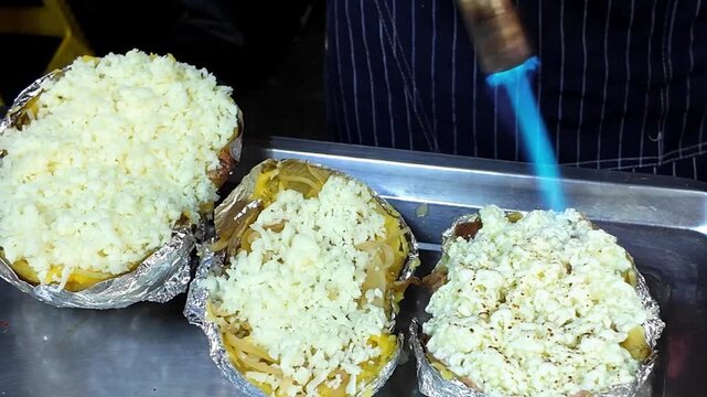 Torching Cheese on Stuffed Baked Potato at Street Food Stall