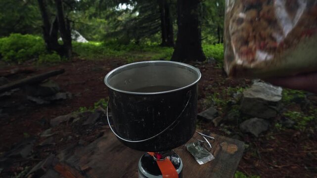 Cooking traditional Ukrainian borscht from dried ingredients during a hiking and camping trip in nature