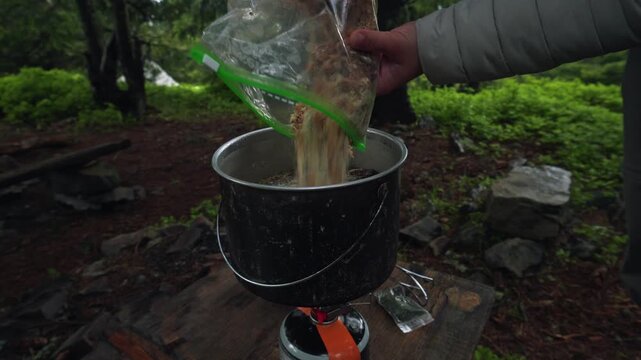 Cooking traditional Ukrainian borscht from dried ingredients during a hiking and camping trip in nature