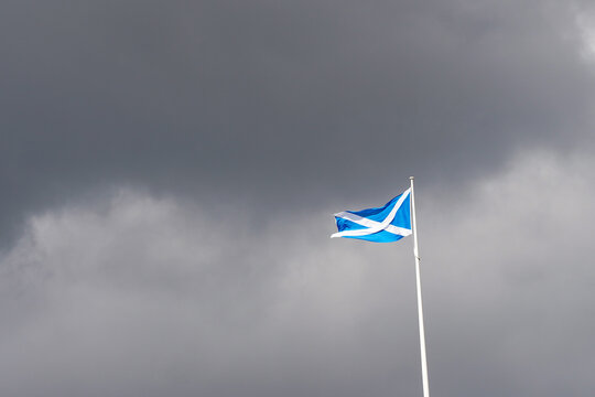 The national flag of Scotland with cloudy background