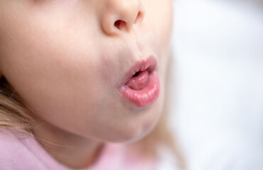 Fototapeta premium Child rolling tongue, Young girl sticking out tongue, playful expression, tongue visible, speech therapy, pronunciation practice session, practicing sounds, oral anatomy health, dental tongue exercise