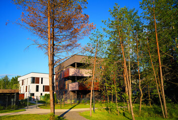 Modern contemporary apartment building with secure gated under croft parking. Development cityscape with housing in low-density. Business-class house with flats. City apartment in multi-family house © MaxSafaniuk
