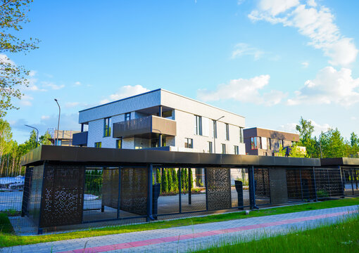 Modern contemporary apartment building with secure gated under croft parking. Development cityscape with housing in low-density. Business-class house with flats. City apartment in multi-family house