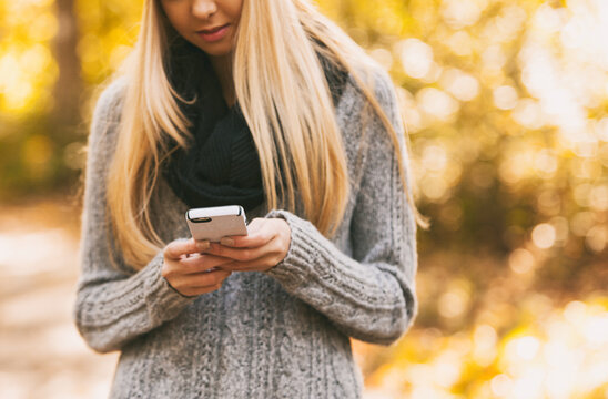 Autumn: Woman Checking Text Messages During Walk