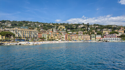 Fototapeta premium Scenic panoramic view of the colorful waterfront buildings and beach from the sea, Santa Margherita Ligure, Italy