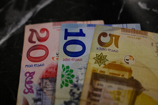 Georgian money, 5, 10 and 20 lari banknotes close-up. Close-up of Georgian lari currency notes (5, 10, 20 GEL bill)