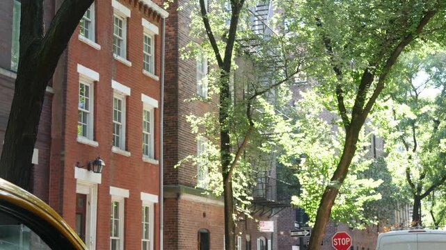 New York City urban residential buildings architecture, Manhattan classic street, Greenwich village, United States of America. Typical red brick house in NYC, real estate property in USA. West village