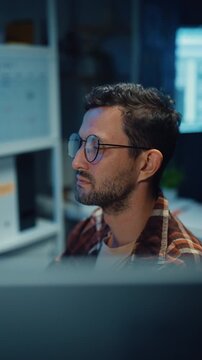 Vertical Screen : Close up young Male programmer hands typing on keyboard in office at night. AI technology, cybersecurity, software developer, freelance innovation, database system, digital network.