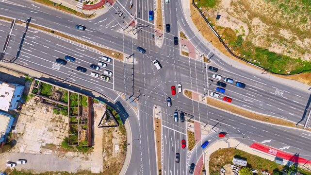 Daylight view of busy crossroad traffic flow, Bratislava, Slovakia. Elevated perspective of cars and trucks driving through a large city intersection.