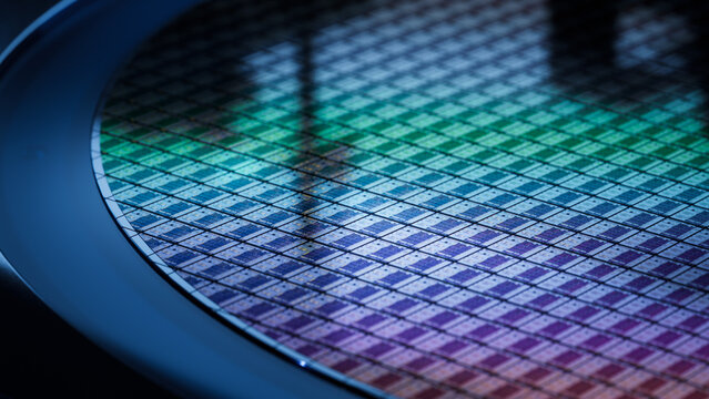 Computer Chip Manufacturing. Close-up of Colorful Semiconductor Wafer that is just was Diced during Microchip Packaging Process. Silicon Dies are being Extracted by a Pick and Place Machine
