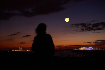 Fototapeta premium Woman observing stars, planets, Moon and other celestial objects.