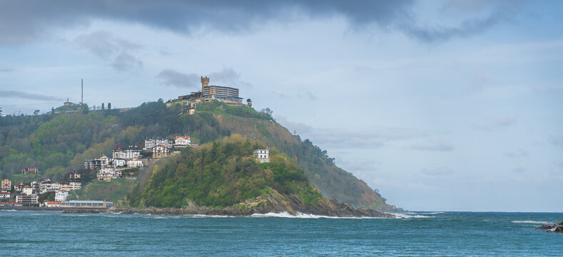 Monte Igueldo hill with historic tower and hotel above rocky coastline, San Sebasti&aacute;n, Basque Country, Spain