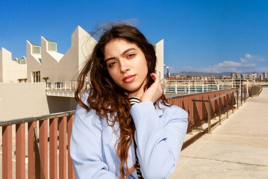 Young Woman Poses Outdoors  in Bright Sunlight