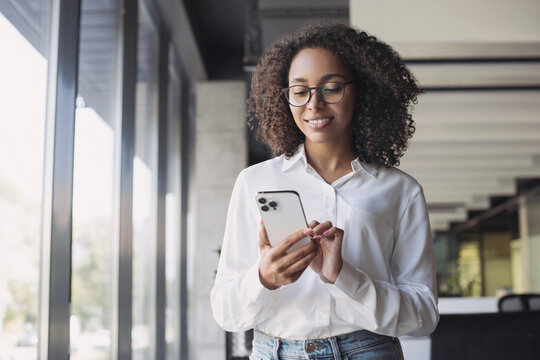 Business woman using smartphone in modern office, Student girl texting on mobile phone indoors, Communication, connection, mobile apps, technology, business lifestyle concept.