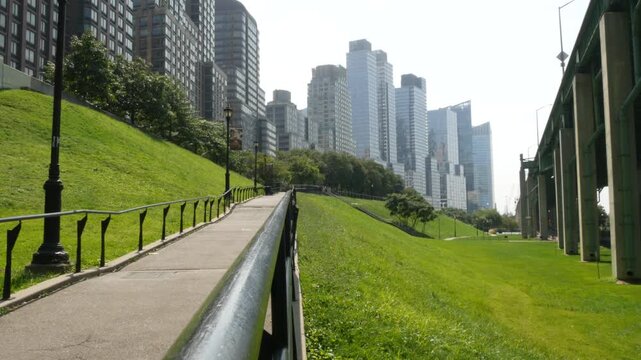 New York City Riverside Park South, Manhattan, United States. Modern residential buildings in Upper West Side. Urban skyscraper skyline, luxury apartments, condos. Summer green grass lawn, riverfront.