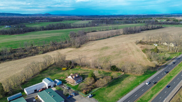 Rural landscape corridor transition showcases expansive agricultural plots alongside US 202. Wide angle perspectives define geographic scope, land use patterns surrounding commercial hub, NJ