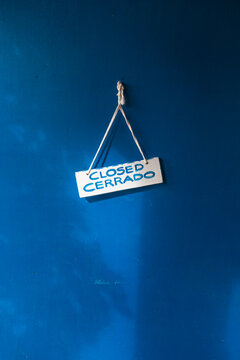 Closed sign on a blue door