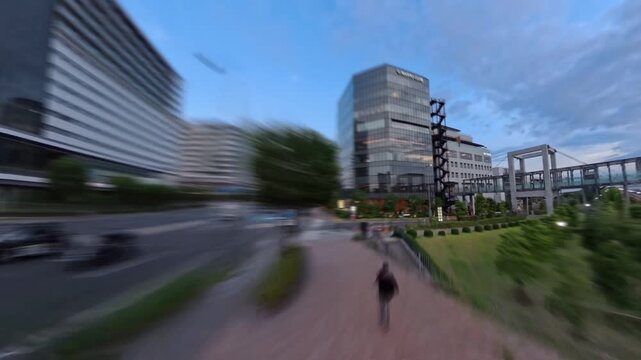 TOKYO, JAPAN - JUNE 2026 : High angle tracking shot of luxury skyscraper apartments and modern waterfront in Toyosu area. Real estate and metropolitan living concept video. Sunset time lapse shot.