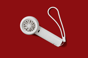 Minimalist White Portable Handheld Mini Fan Isolated on Red Background, Easy for Di-Cut PNG © punpolpoke