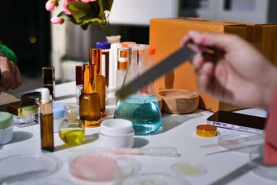 Woman making organic cosmetics with aloe in laboratory