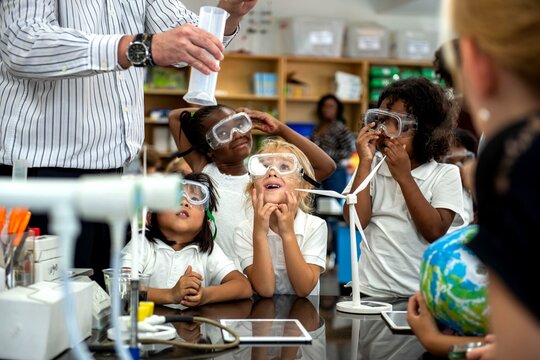 Children engaged in science experiment.