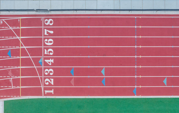 Aerial view of a red running track with numbered lanes and white markings in Las Vegas, Nevada, United States.