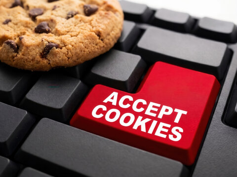 Computer cookie on keyboard with accepting cookies button, website information save in browser