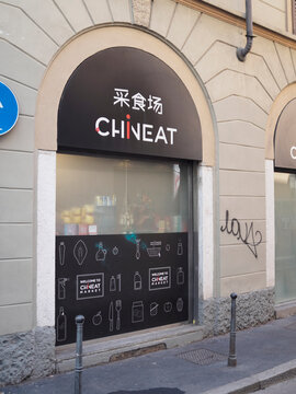 Chineat Market storefront in Milan Chinatown, Via Paolo Sarpi, featuring an Asian grocery and street vibrancy