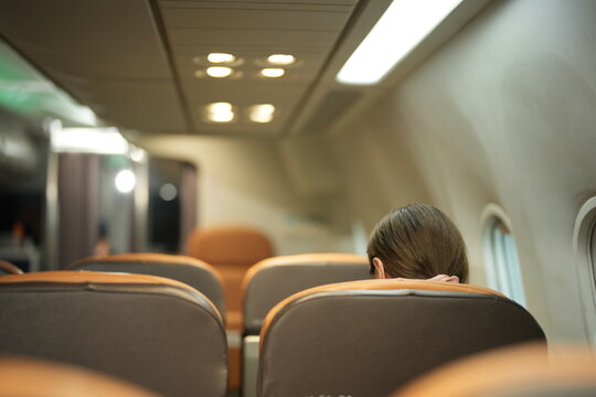 Elegant passenger sitting in a comfortable business class seat inside an airplane cabin during a premium flight journey