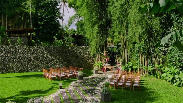 Aerial shot of beautiful minimalistic and intimate wedding venue surrounded by green trees in Ubud, Bali
