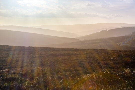 Sunset Over the Misty Countryside of Kielder Northumberland Capturing the Tranquil Landscape Under a Cloud-Filled Sky